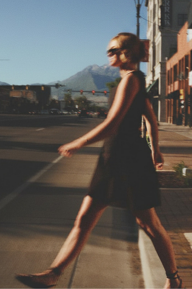 Woman wearing modest little black dress, lifestyle image, downtown